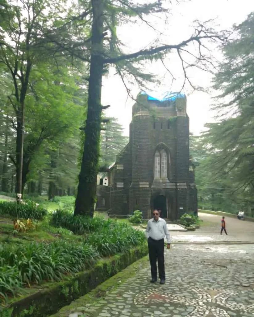 Exterior view of the neo-Gothic St. John in the Wilderness Church surrounded by deodar pine forests