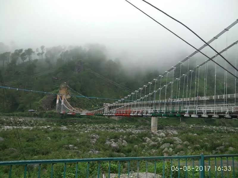 Neugal Khad suspension bridge under low mist and cloudy skies in Palampur