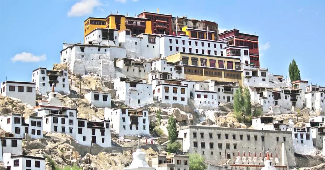 Panoramic view of the iconic Thiksey Monastery perched on a hill in Ladakh.
