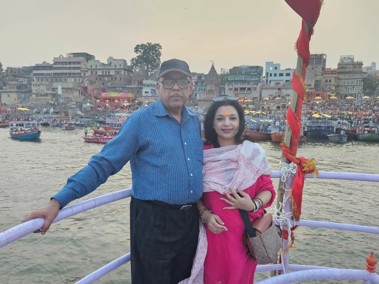 Traditional structures and colorful flags adorning the steps of Dashashwamedh Ghat