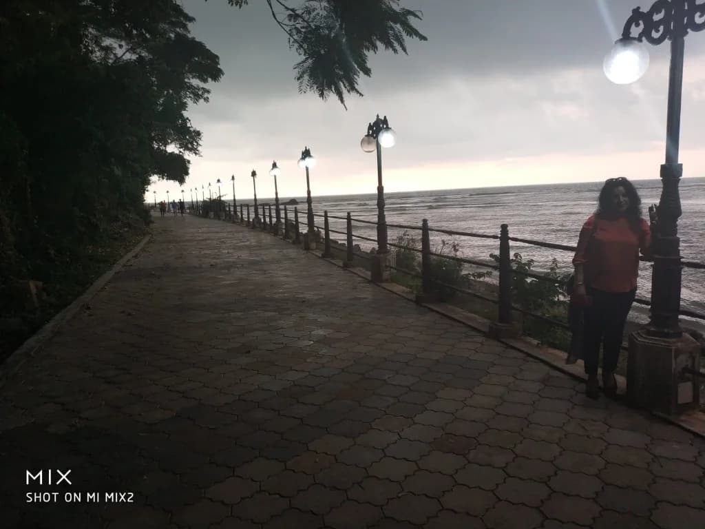 Evening promenade with illuminated street lamps overlooking Malabar coast