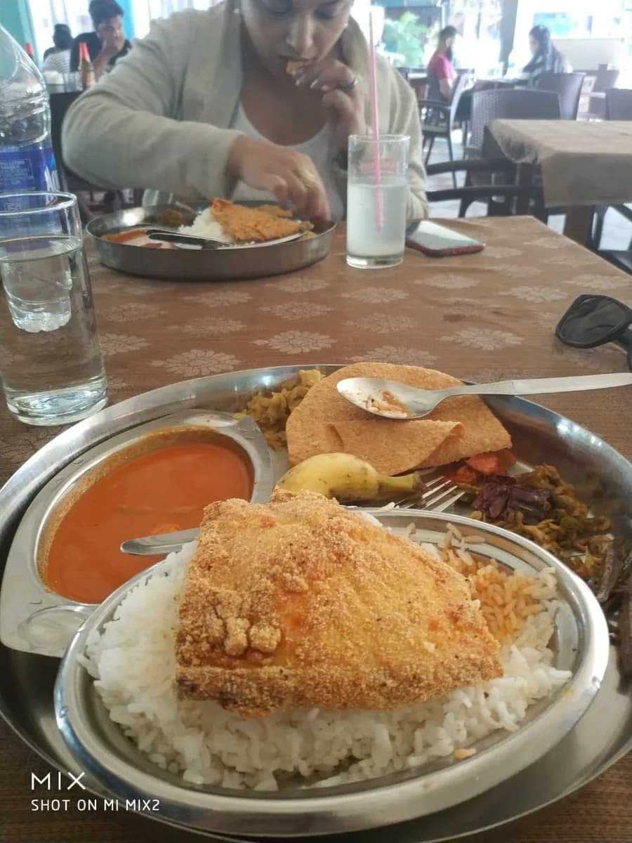 Classic Goan fish thali with rava-fried fish, coconut fish curry, and rice