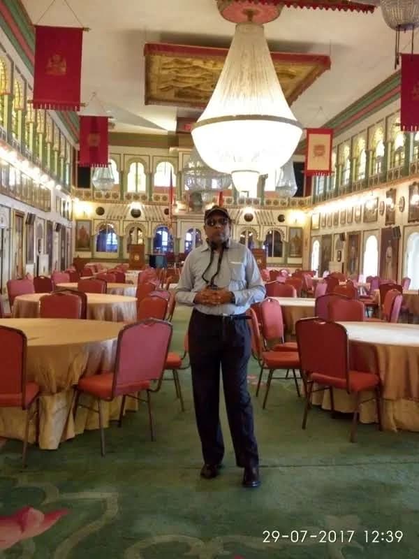 Massive central crystal chandelier suspended from the high ceiling of Durbar Hall in Udaipur City Palace