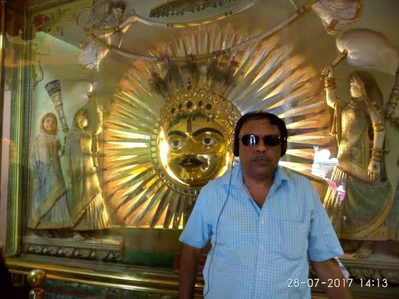 Golden Sun God Surya emblem with radiant golden rays and royal attendants at Surya Chopar in Udaipur City Palace
