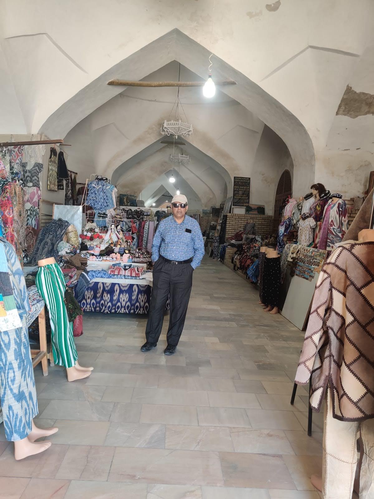 Bustling historical bazaar in Bukhara showing colorful carpets and traditional architecture