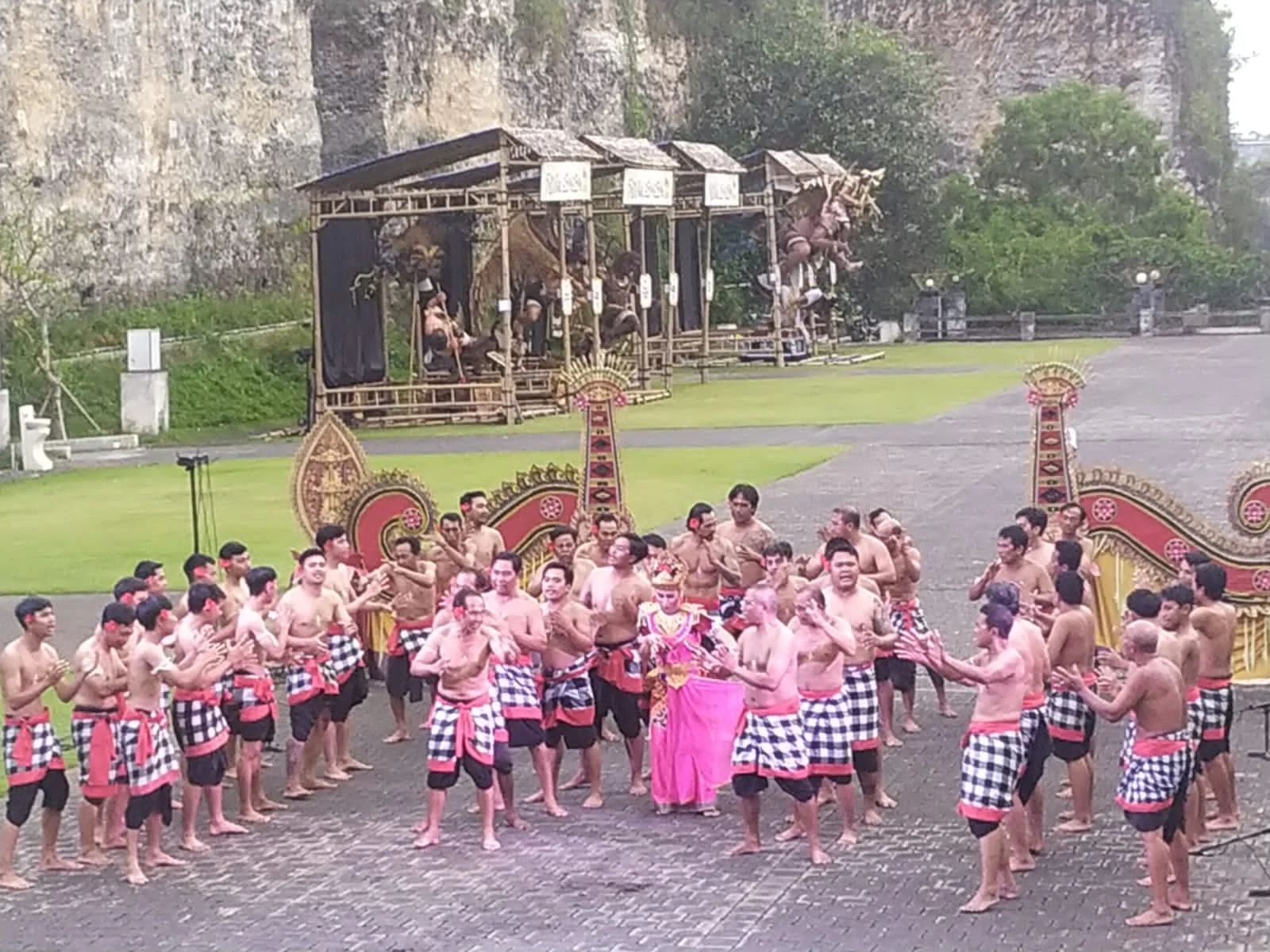 The bare-chested human choir chanting in checkered poleng sarongs during the Kecak Garuda Wisnu Kencana dance