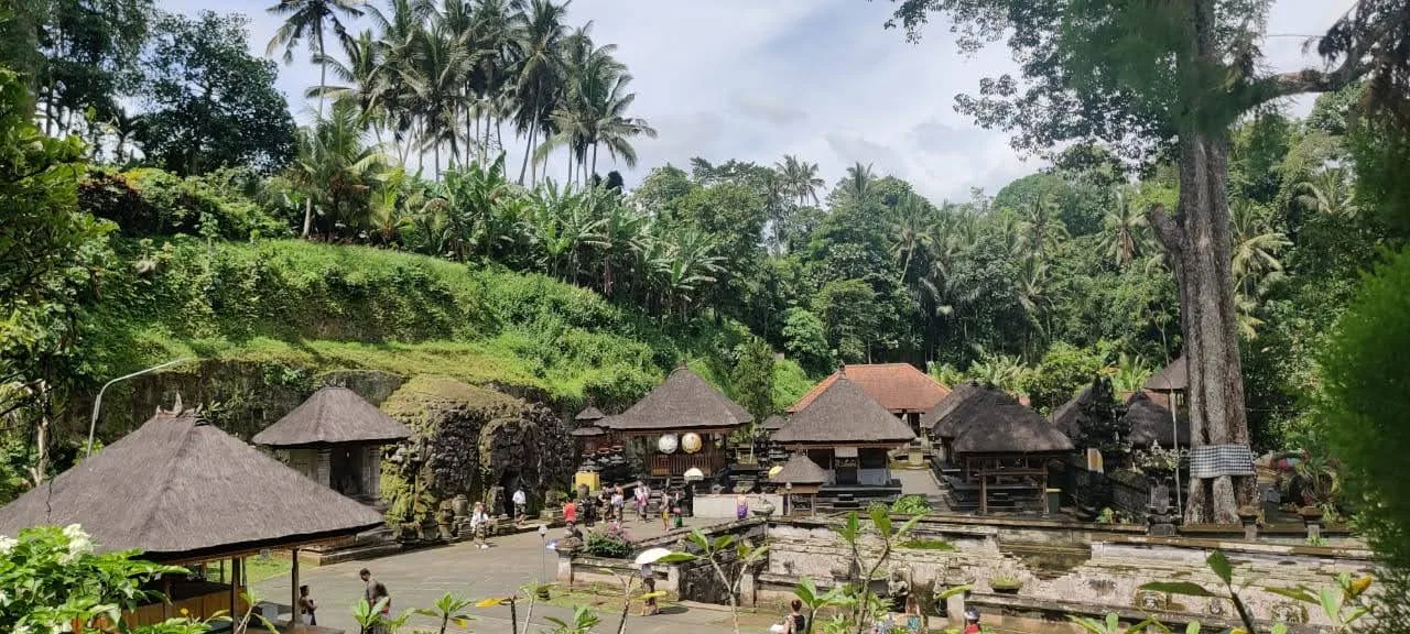 Scenic panoramic overlook of sacred temple sanctuary surrounded by lush tropical jungle and palms