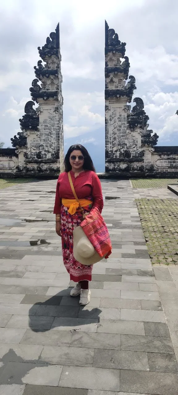 Lady traveler in traditional Balinese sarong before the Gates of Heaven at Pura Lempuyang