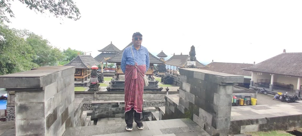 Gentleman traveler on the upper terrace overlook with Bale pavilions and Meru towers in background