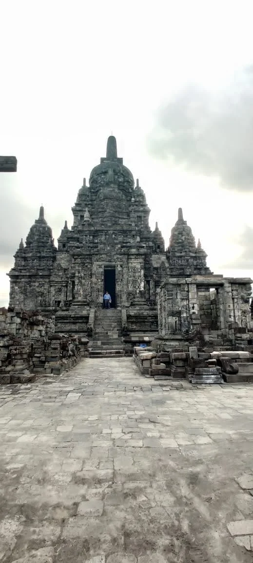 Ceremonial entrance stairway leading into the elevated sanctuary of Candi Sewu with traveler in portal