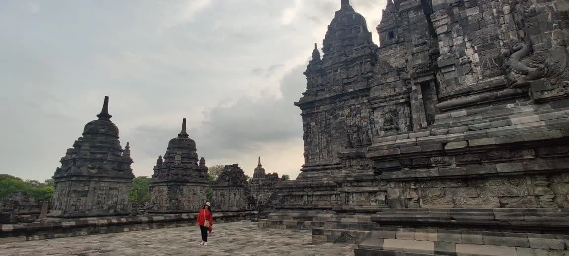 Traveler exploring the surrounding stupas and perimeter shrines of Candi Sewu