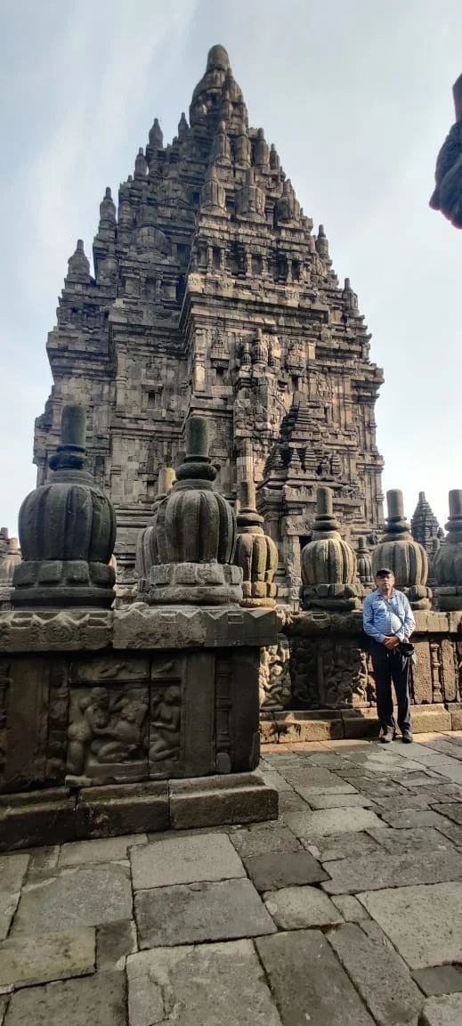 Ornamental ratna stone finials crowning the upper tiers of Prambanan with traveler