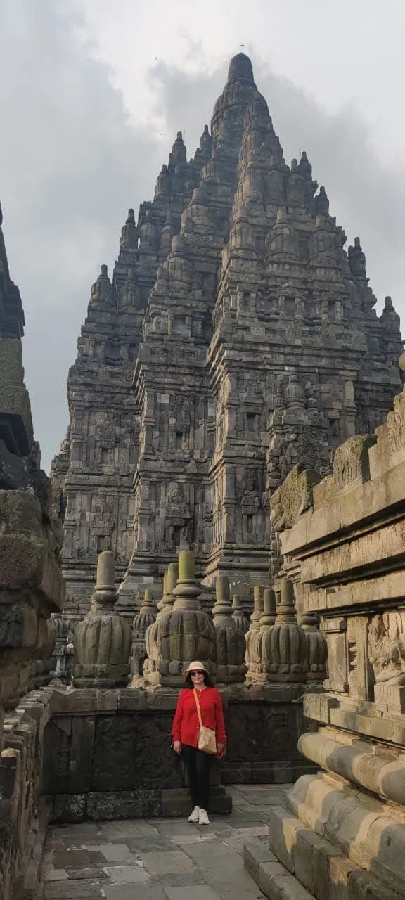 Traveler walking through the inner stone courtyards surrounded by Prambanan's towering temples