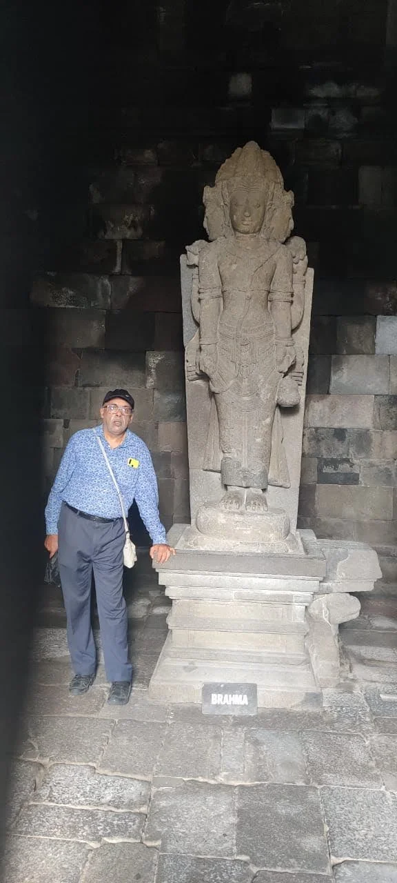 Four-faced stone statue of Lord Brahma with stone inscription plaque in the Brahma temple