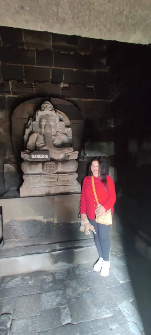 Stone statue of Lord Ganesha with stone inscription plaque inside the central Shiva temple