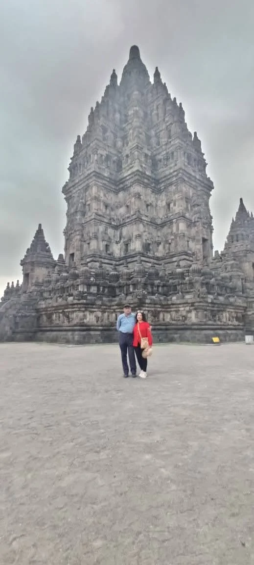 Travelers standing before the soaring 47-meter facade of the Central Shiva Temple