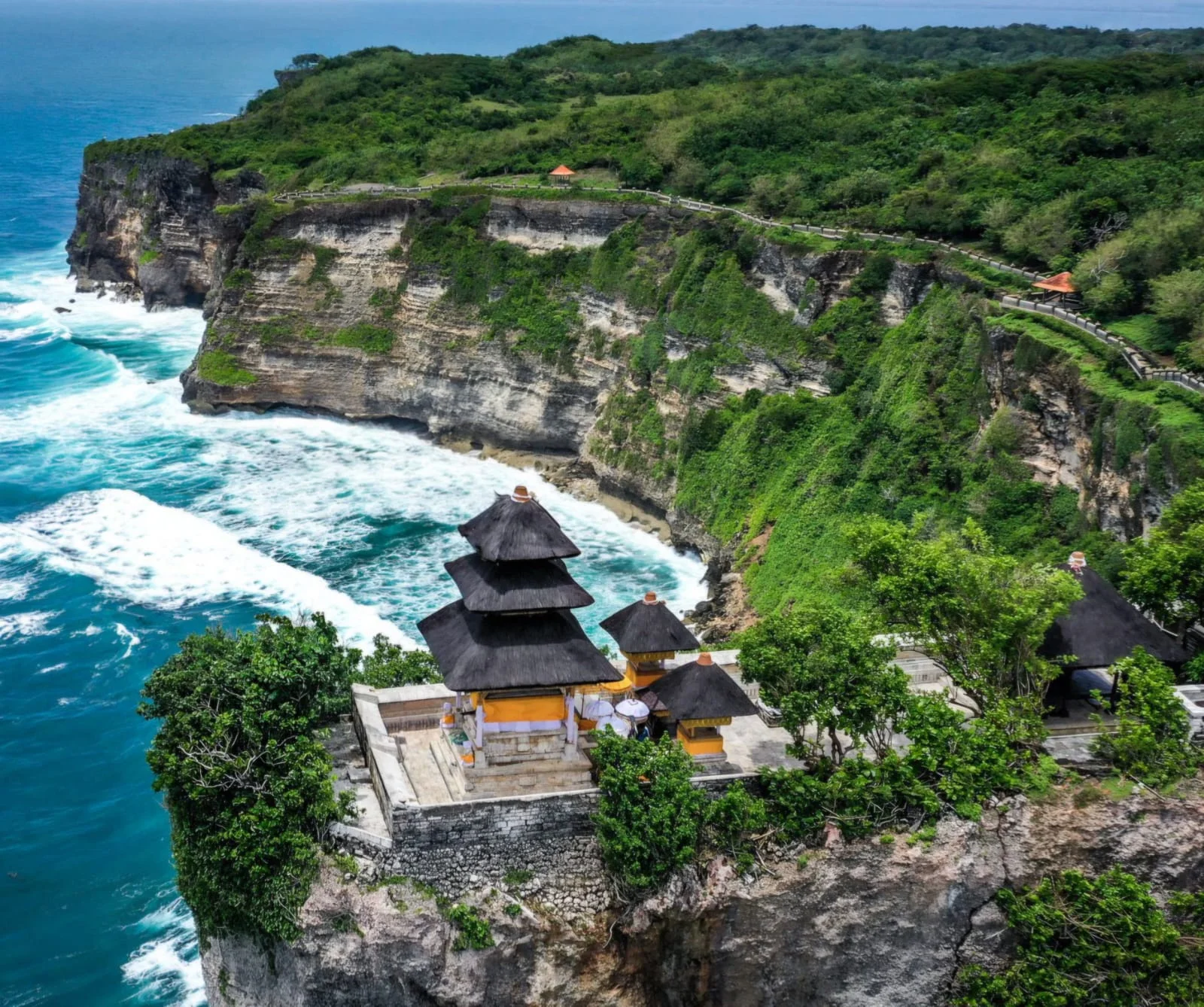 Dramatic clifftop view of Uluwatu Temple perched 70 meters high over the Indian Ocean in Bali