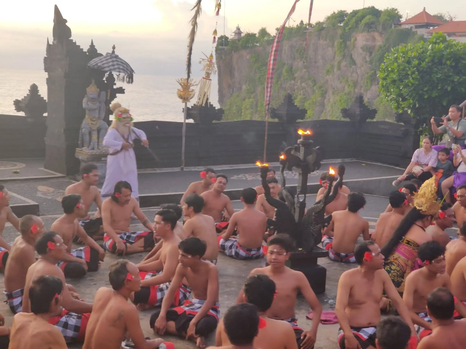 Dramatic entrance and stone altar area at Uluwatu with performers preparing for the sacred fire rituals