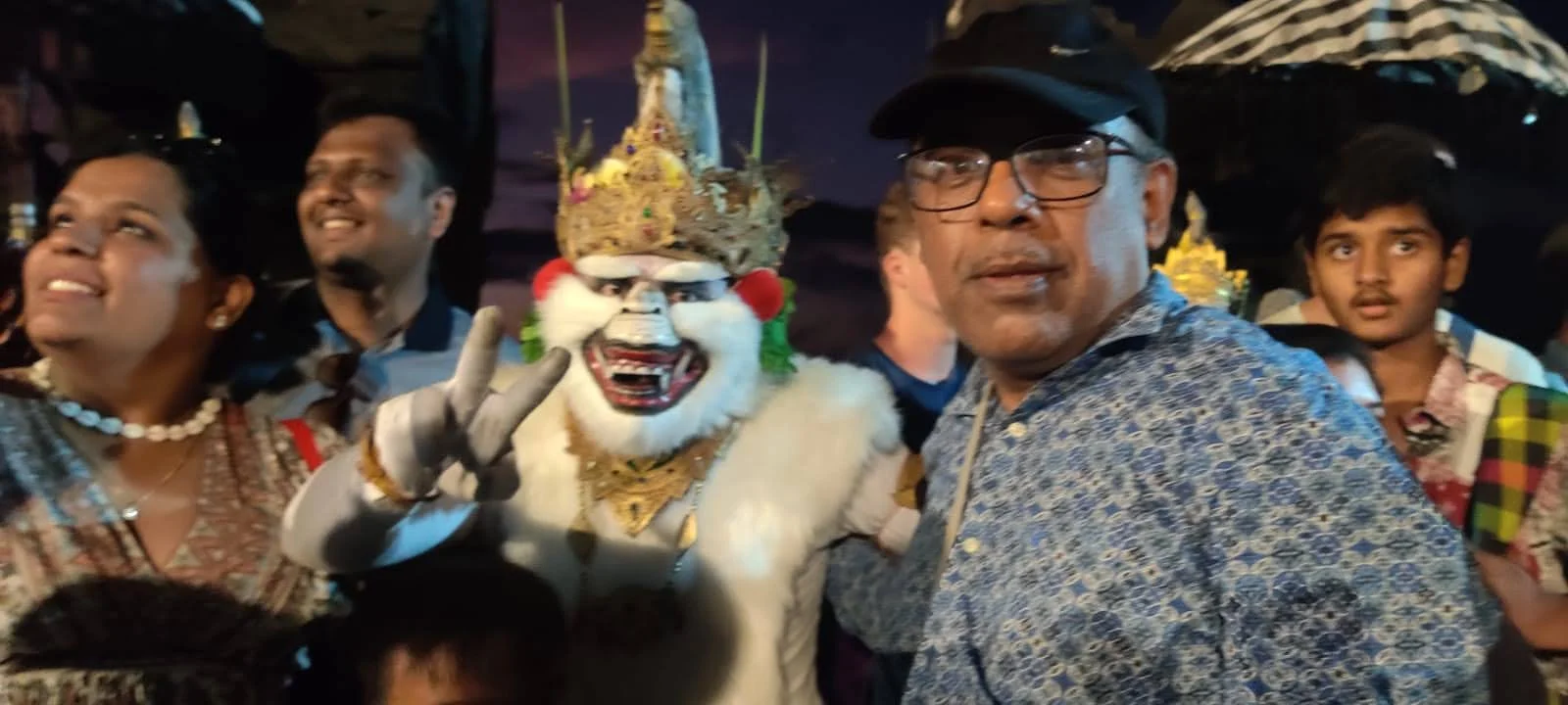 Gentleman traveler sharing a smile with the actor portraying Hanuman making a peace sign