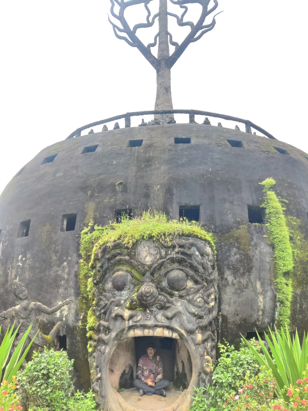 Traveler stepping into the three-metre-tall gaping demon mouth portal entrance to the underworld of the pumpkin structure