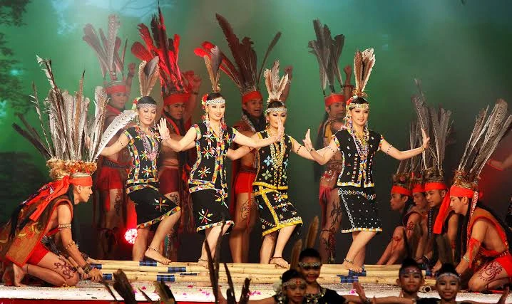 Traditional indigenous warrior dance choreography being performed on stage with shields and ceremonial swords