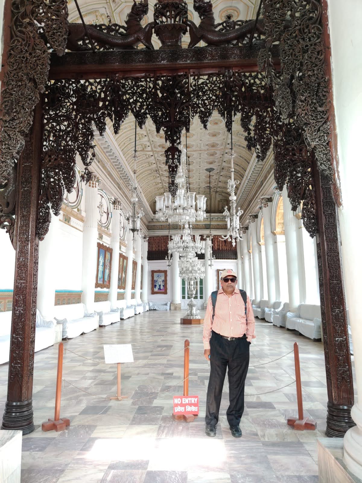Gaddi Baithak Royal Audience Hall interior with crystal chandeliers and carved wooden torana archway