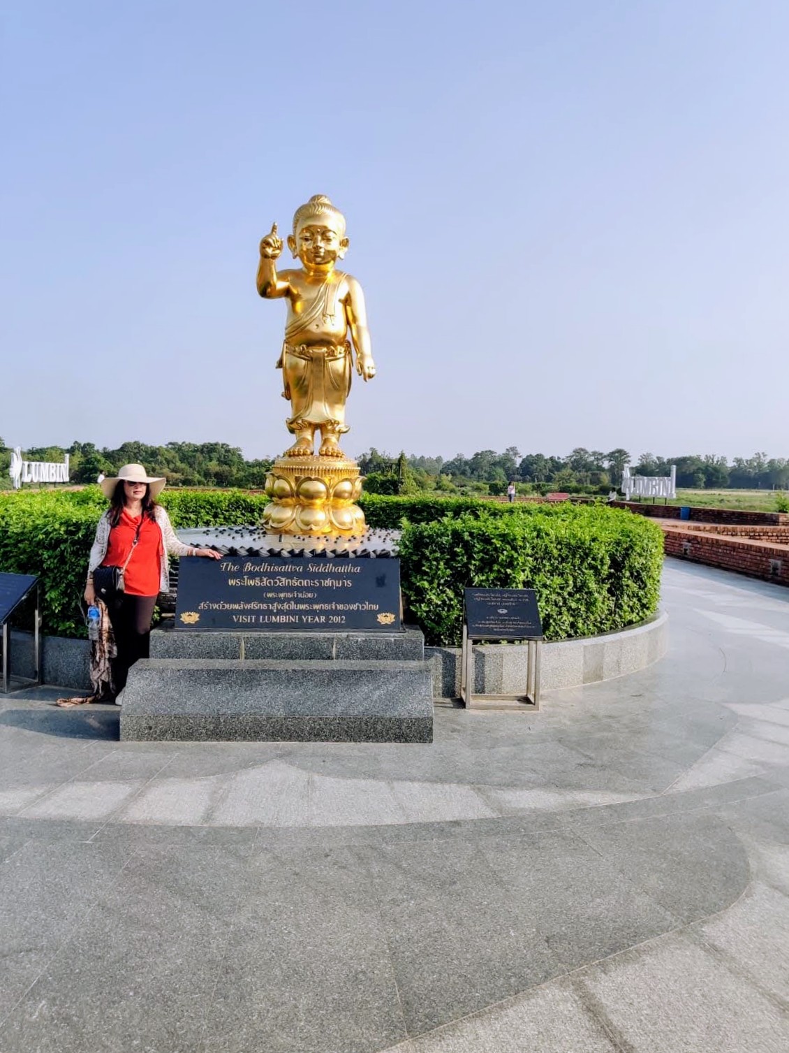 Golden statue of baby Bodhisattva Siddhartha Gautama standing on a lotus pedestal in Lumbini