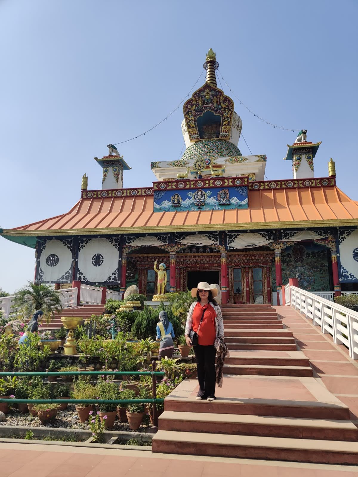 Exterior of the Great Drigung Kagyud Lotus Stupa with golden pinnacle and ornate Tibetan lintels