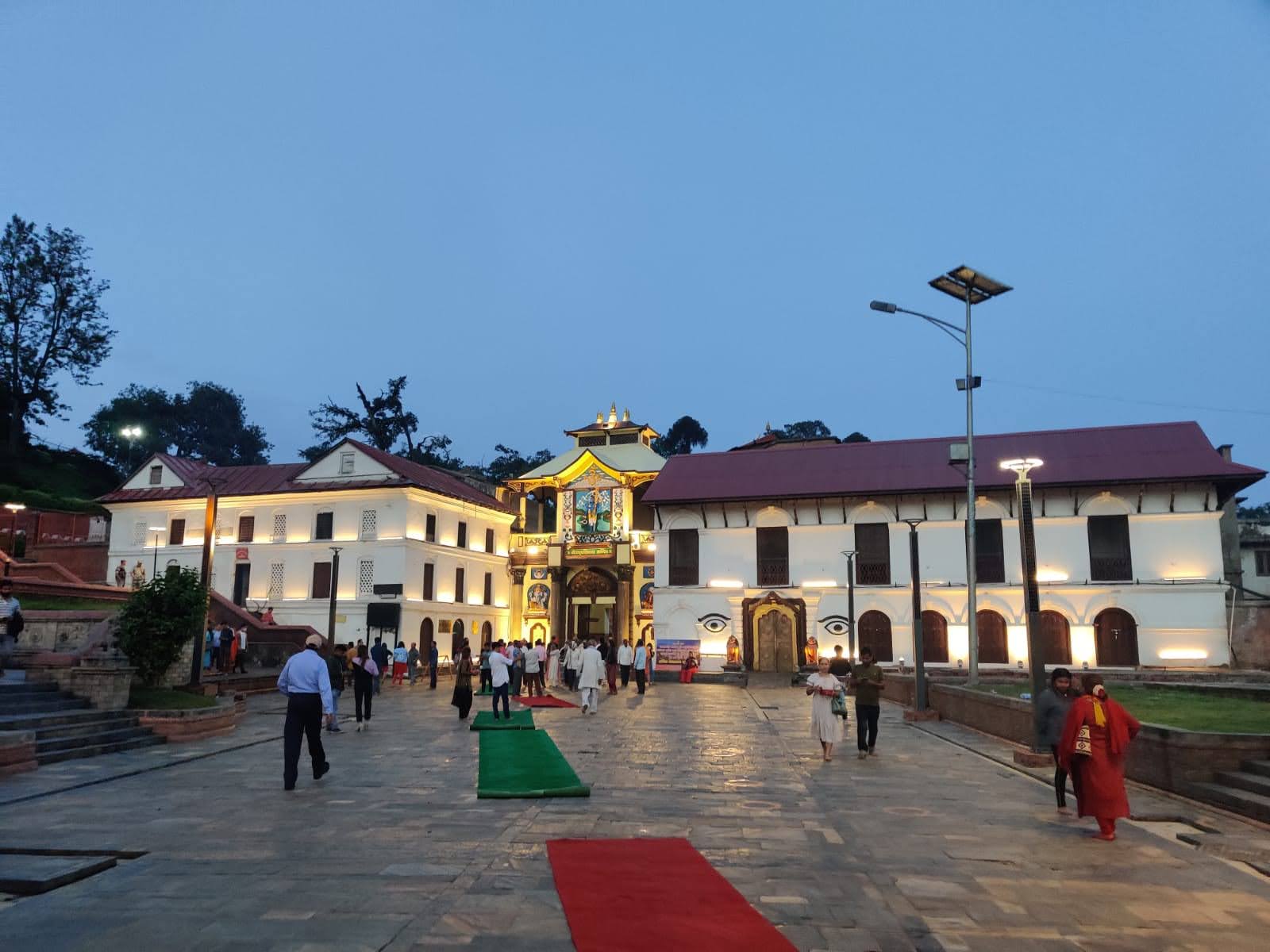 Pashupatinath Temple grand entrance plaza and illuminated traditional pavilions at twilight in Kathmandu, Nepal