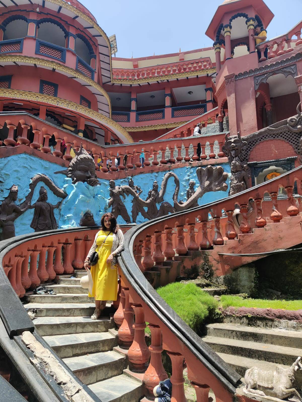 Grand spiral staircase with Hindu deity and Naga carvings at Gupteshwor Mahadev Cave in Pokhara