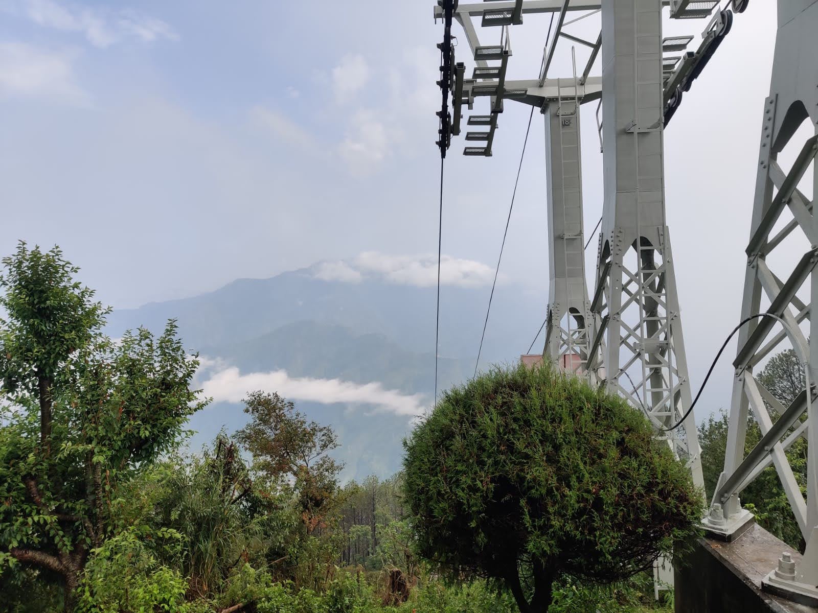 Manakamana cable car tower perched on a misty mountain ridge overlooking the Himalayas