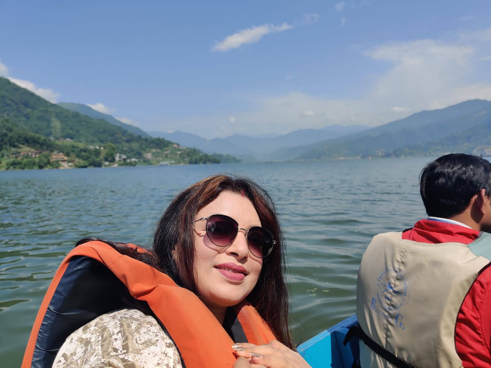 Gliding across Phewa Lake in a wooden boat towards Tal Barahi Temple with the boatman
