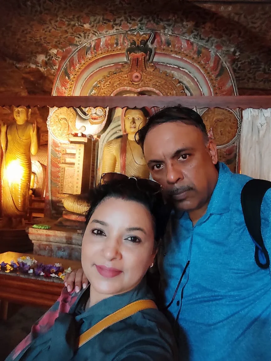 Ornate Makara Torana dragon arch framing seated Buddha inside Dambulla cave