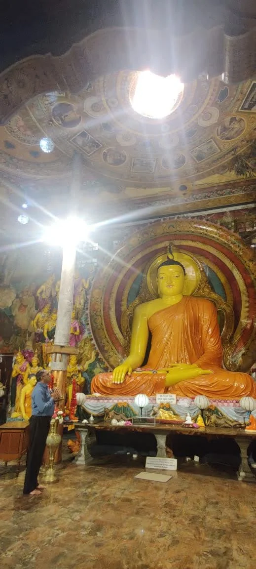 Gilded Buddha images, crystal chandeliers, and monastic treasures inside Gangaramaya main hall