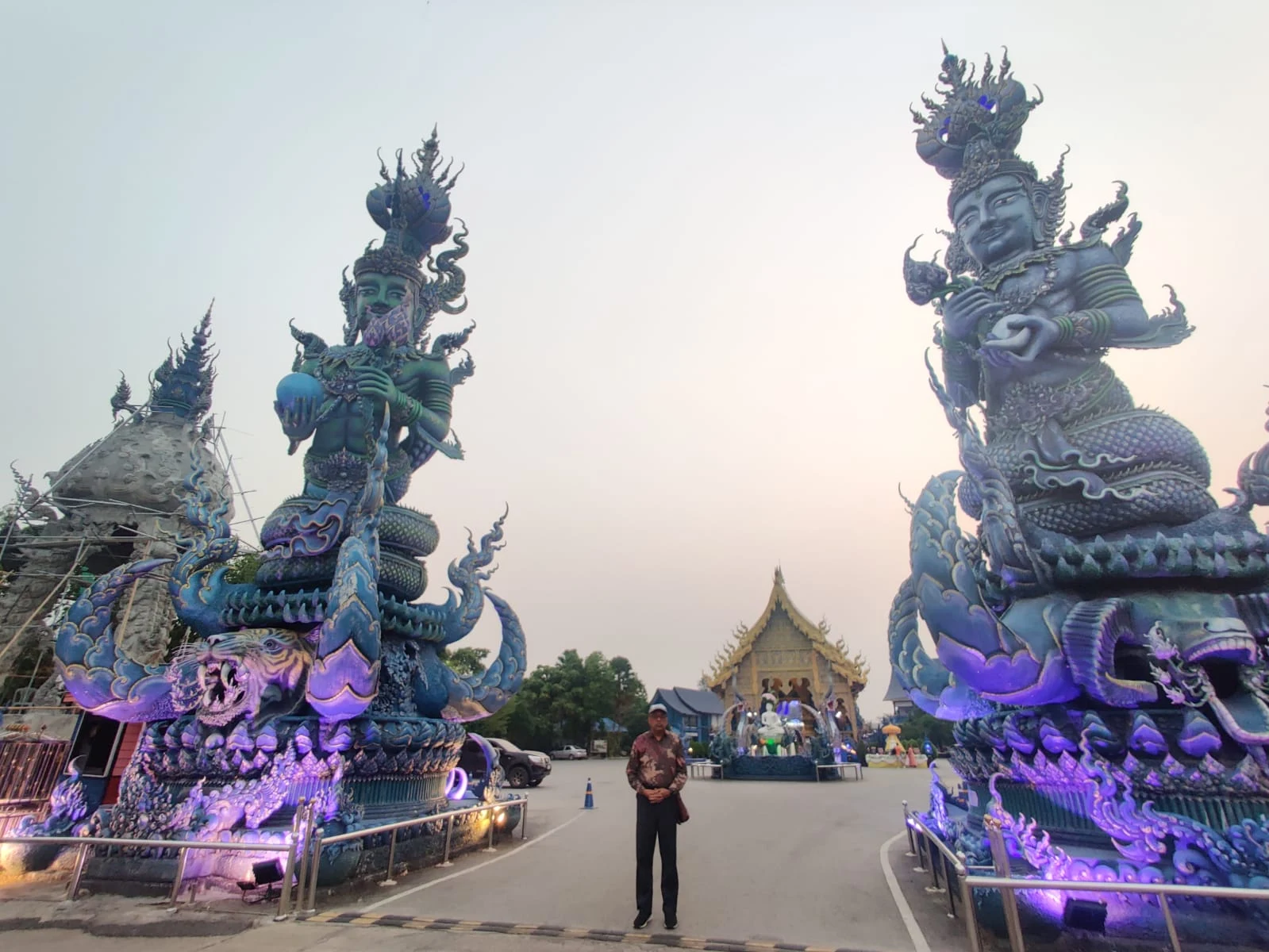 Towering mythical demon Yaksha guardians flanking the entrance of the Blue Temple