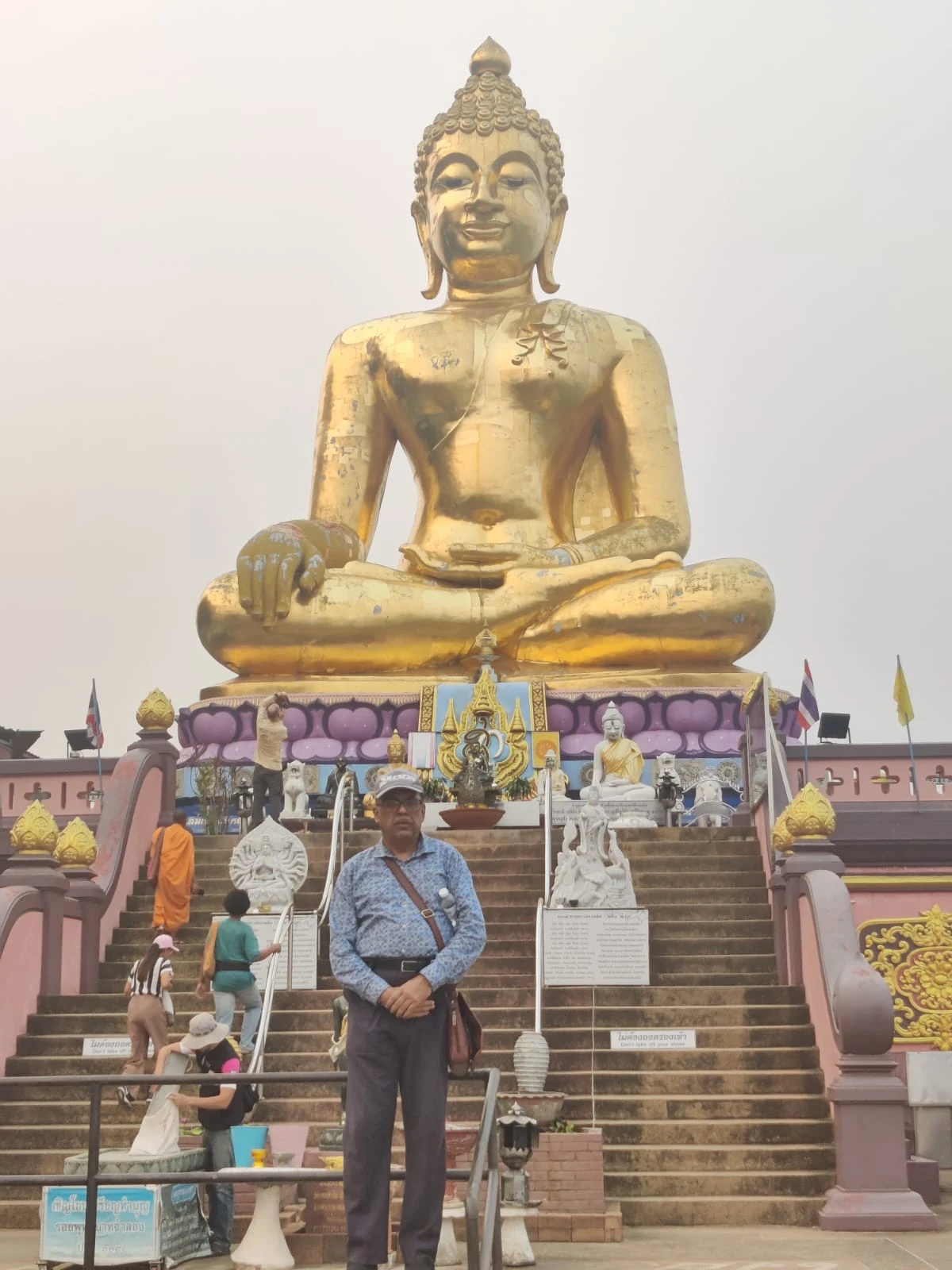 Colossal Golden Buddha seated on a dragon boat overlooking the Mekong River at the Golden Triangle