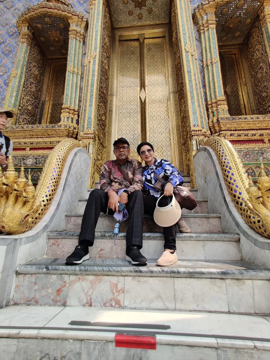 Wanderers at 50 couple seated on marble Naga balustrade stairs