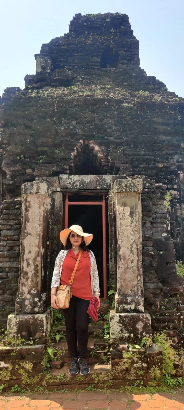Traveler standing in the entrance portal doorway of an ancient brick tower