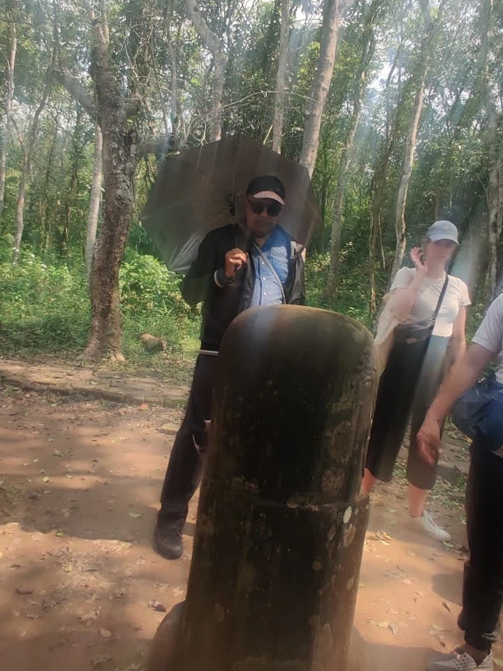 Ancient Sanskrit stone stele pillar on the forest path of My Son Sanctuary