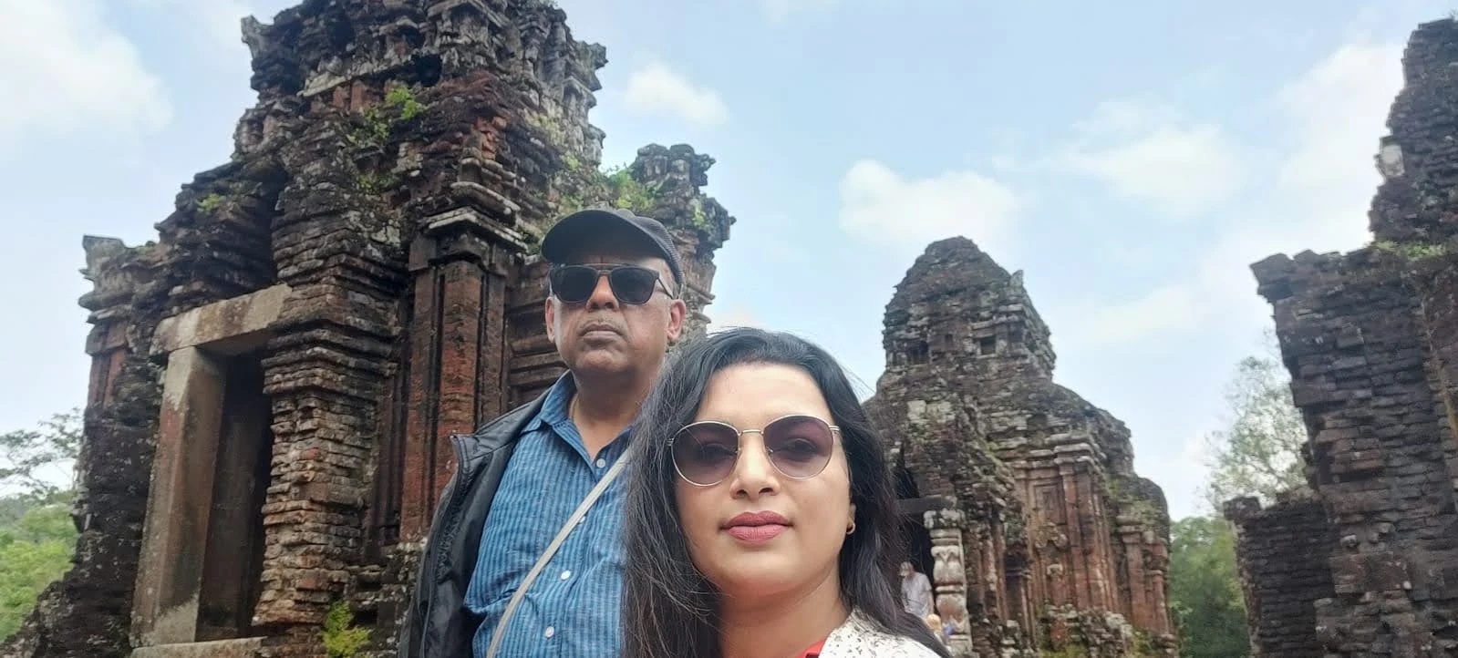 Wanderers at 50 exploring the ancient brick ruins of My Son Sanctuary in central Vietnam