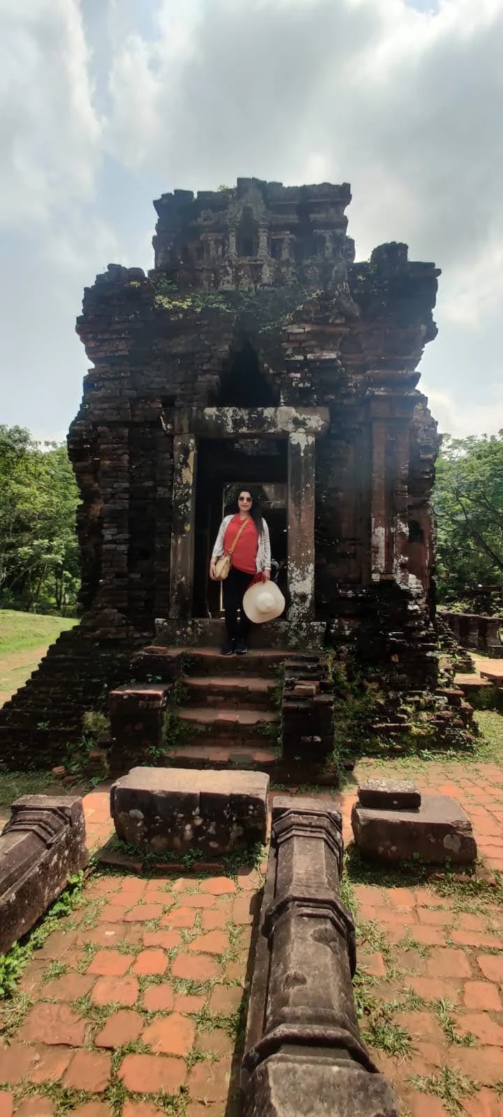 Vertical view of an ancient brick sanctuary tower and pathway at My Son