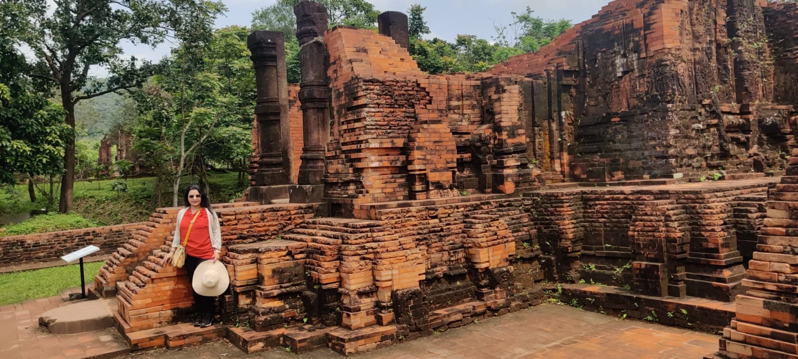Distinctive weathered red brick walls and columns of My Son temple ruins