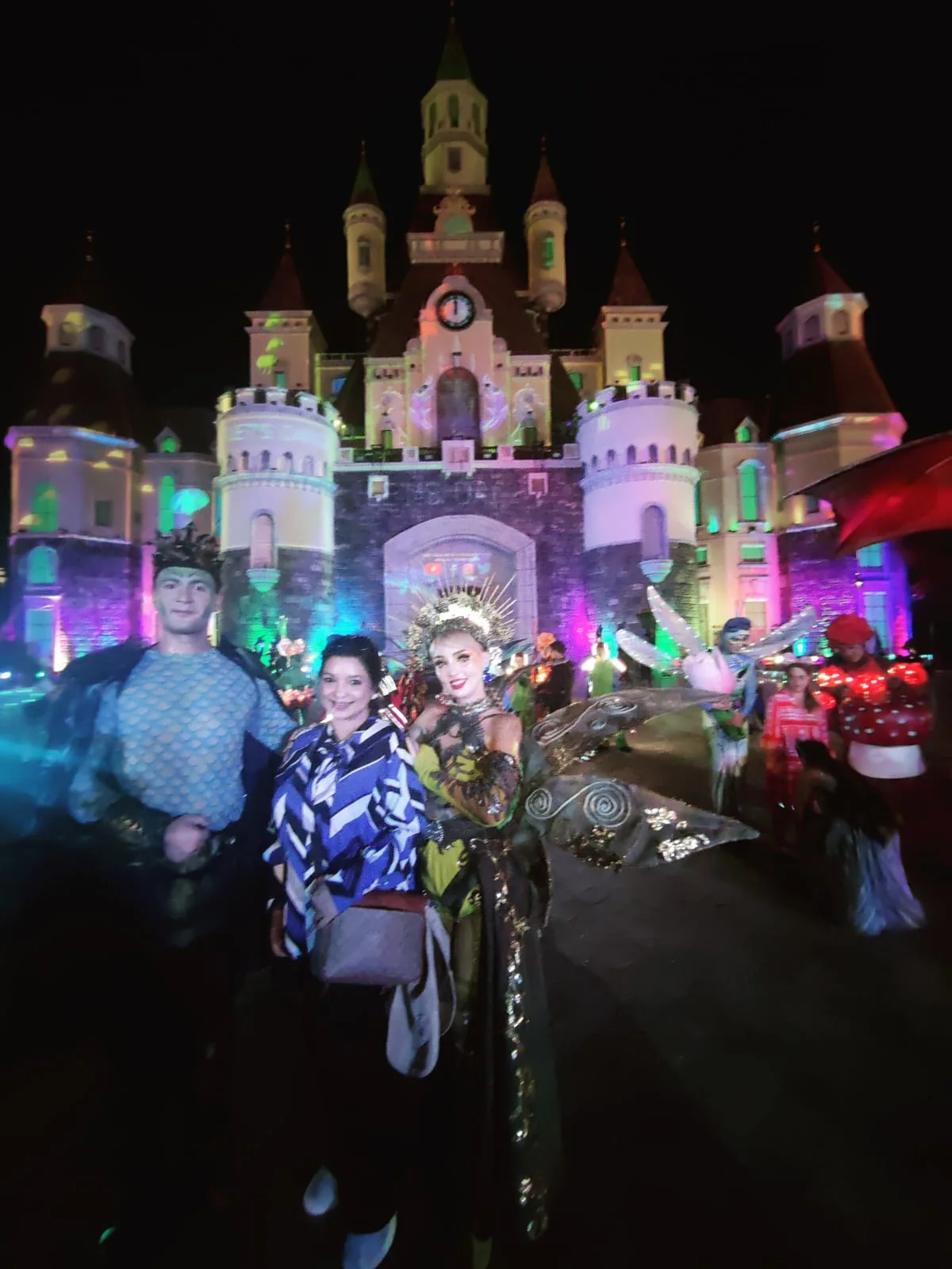 VinWonders illuminated fairytale castle at night with costumed performers