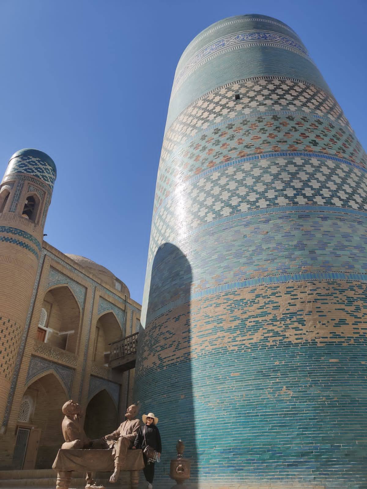 Kalta Minor minaret standing out against clay city walls