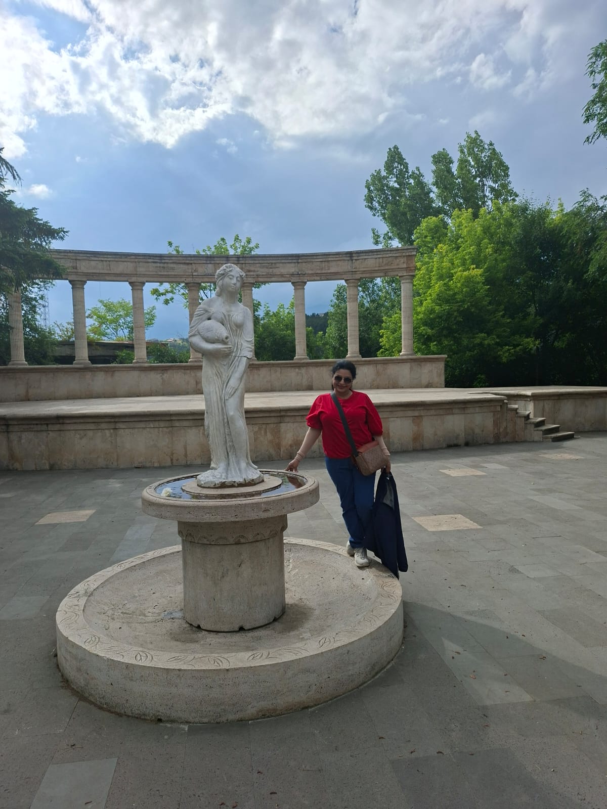 A traditional stone statue set in a verdant park in Vanadzor