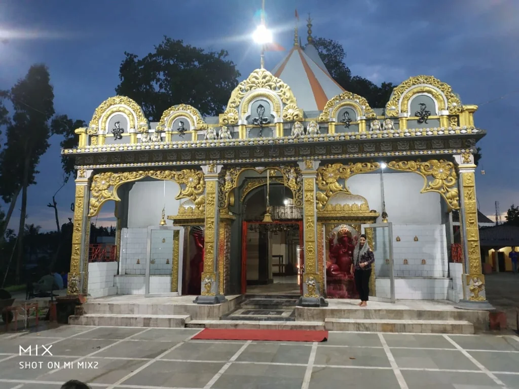Illuminated ornate golden entrance facade of Mahabhairab Temple at dusk