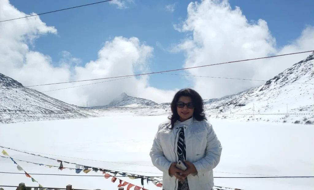 Frozen white Sela Lake with fluttering prayer flags in the crisp Himalayan breeze