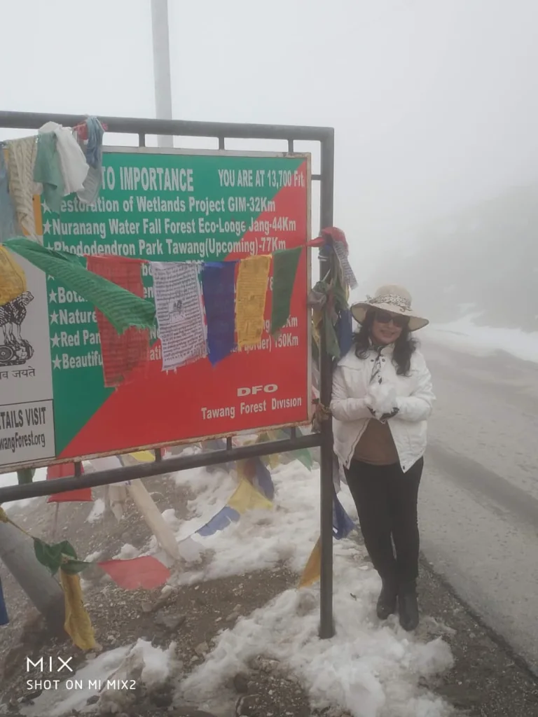 Official altitude milestone sign: YOU ARE AT 13,700 FT at Sela Pass