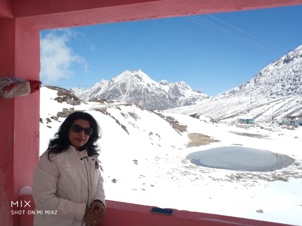 Panoramic view of snow-capped Himalayan peaks and partially frozen Sela Lake