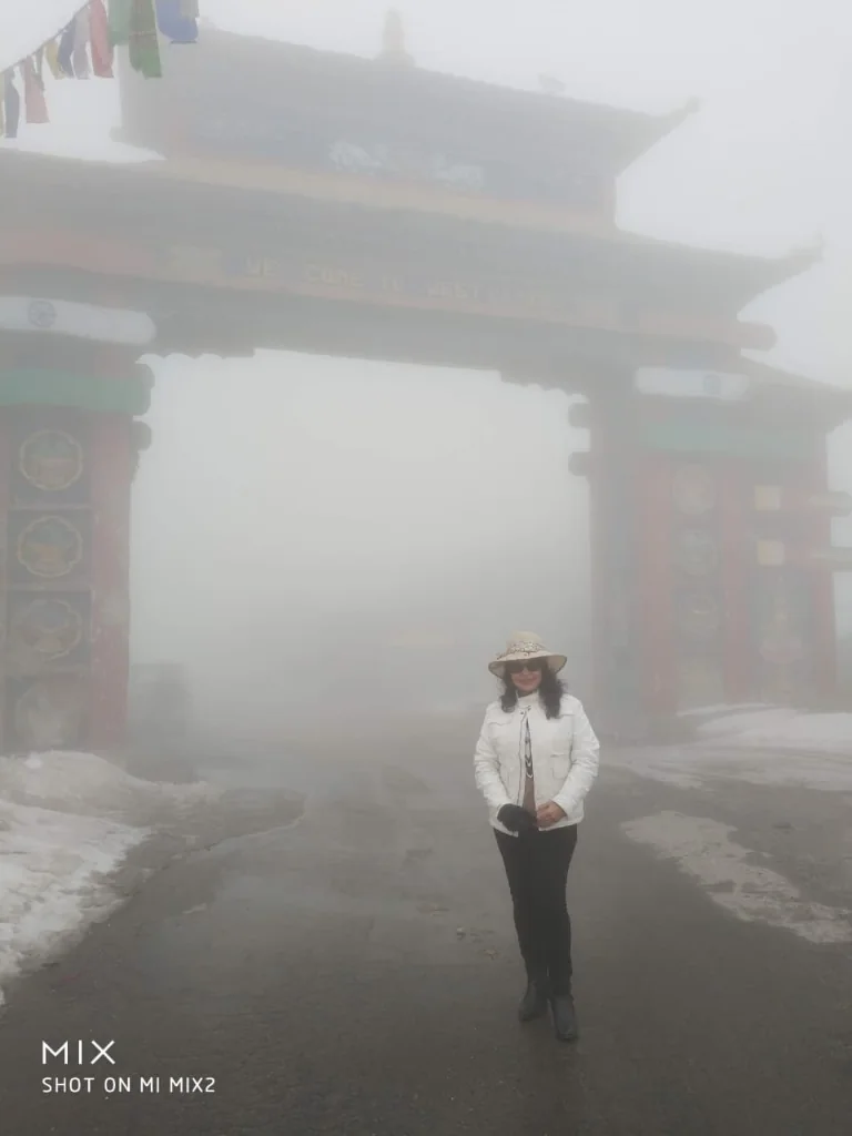 Misty high-altitude welcome arch gate at Sela Pass